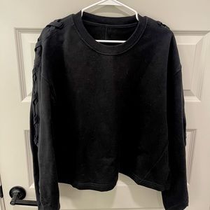 Lululemon Women’s black sweatshirt with detailed sleeves.